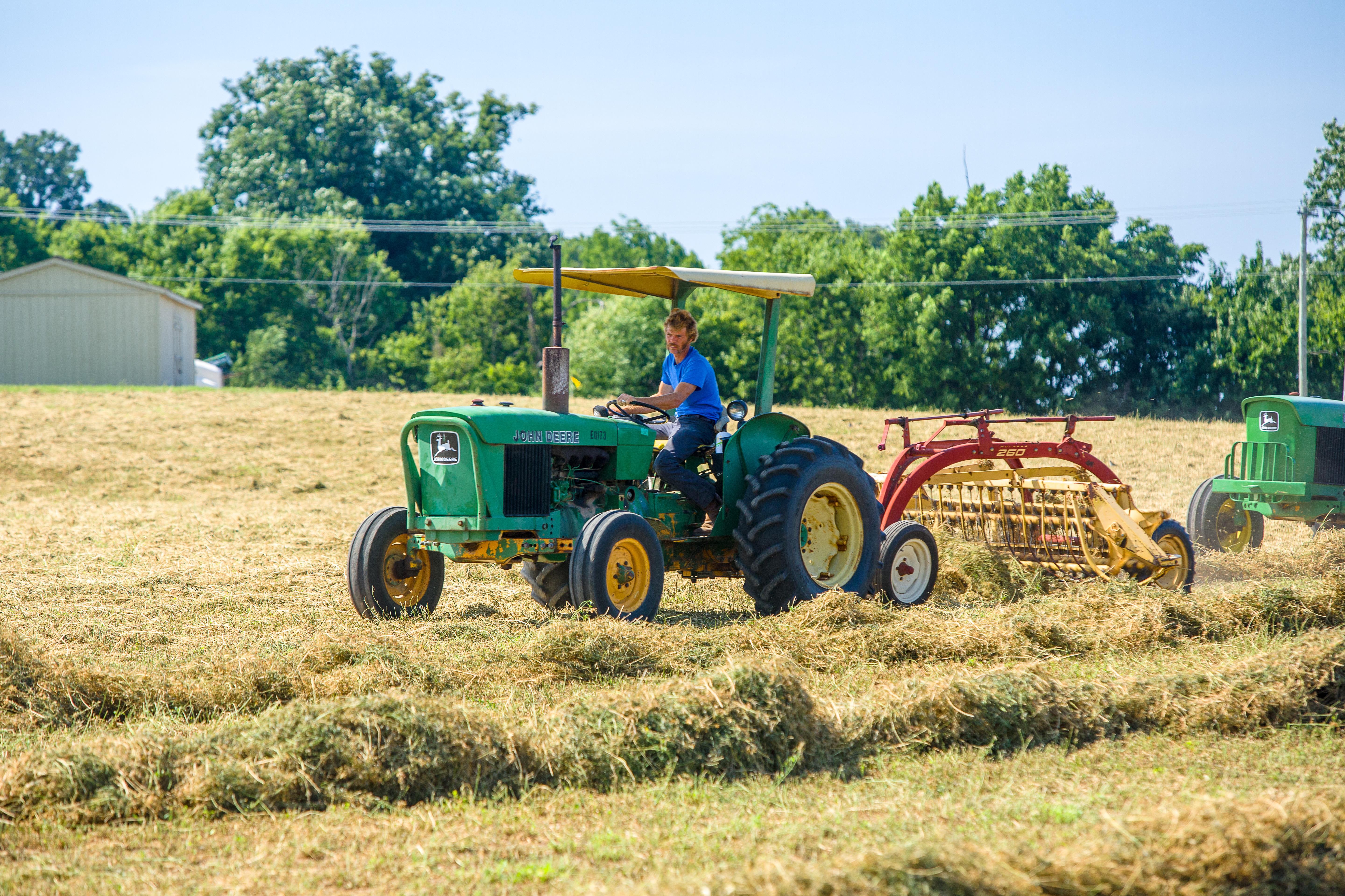 Man operating a John Deere tractor