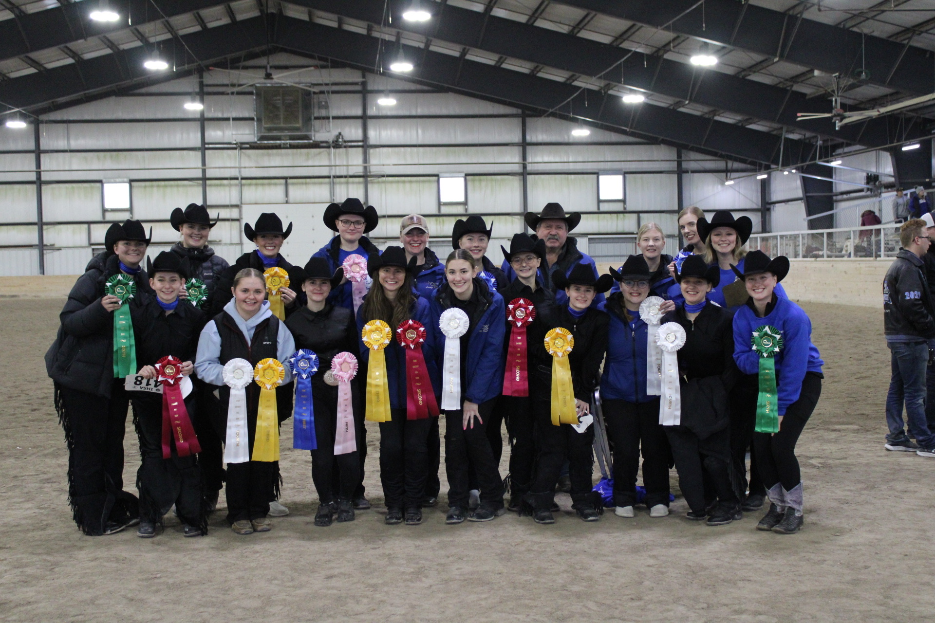 Western Team members holding ribbons at a horse show.